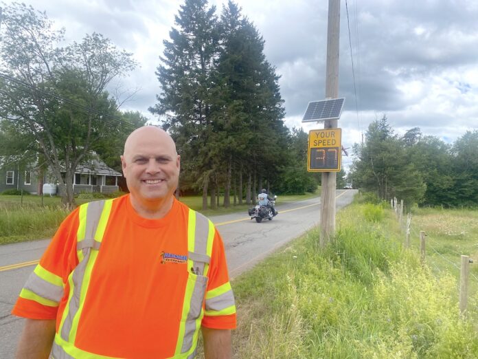 Reicker-Sign-sm Oxford Public Works Supervisor Larry Reicker poses with the town's new Speed Sign on Lower Main St.