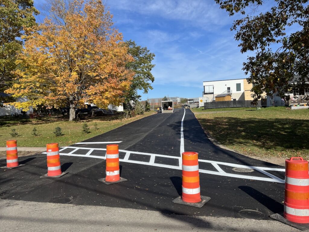 eastlink Centre Lane, freshly paved and now with painted crosswalks, pedestrian and a bike lane.